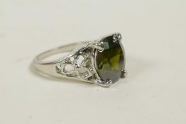 A silver dress ring set with a semi-precious green stone, approximate size 'O/P'