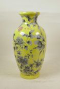 A Chinese yellow ground porcelain vase, with black and white floral decoration, 4 character mark
