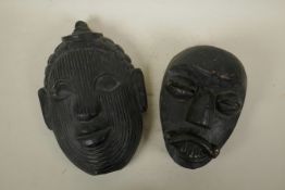 An Oriental carved and lacquered wood Buddha mask, and another Oriental mask, largest 9" x 12"