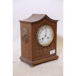 A late C19th inlaid mahogany mantel clock with pagoda shaped top and lion mask handles, the enamel