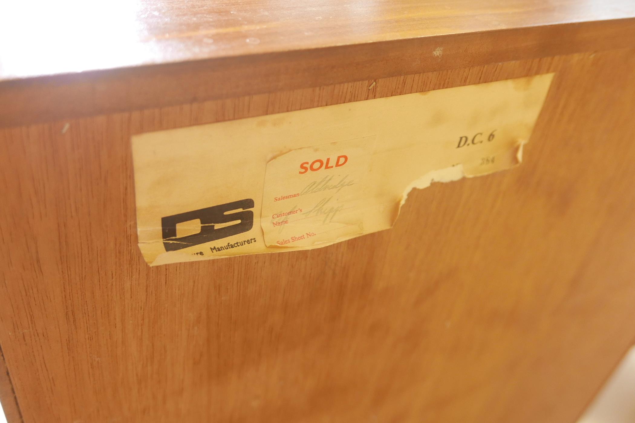 A 1970s teak chest of six drawers, labelled to the reverse, together with a mid century teak mirror, - Image 3 of 4