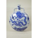 A Chinese blue and white porcelain two handled moon flask decorated with a dragon and the flaming