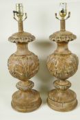 A pair of parcel gilt table lamps carved with acanthus leaves, 21" high