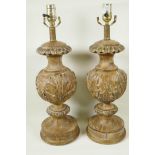 A pair of parcel gilt table lamps carved with acanthus leaves, 21" high