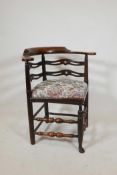 An C18th corner chair with turned supports and stretchers, and pierced decoration to the back, 30"