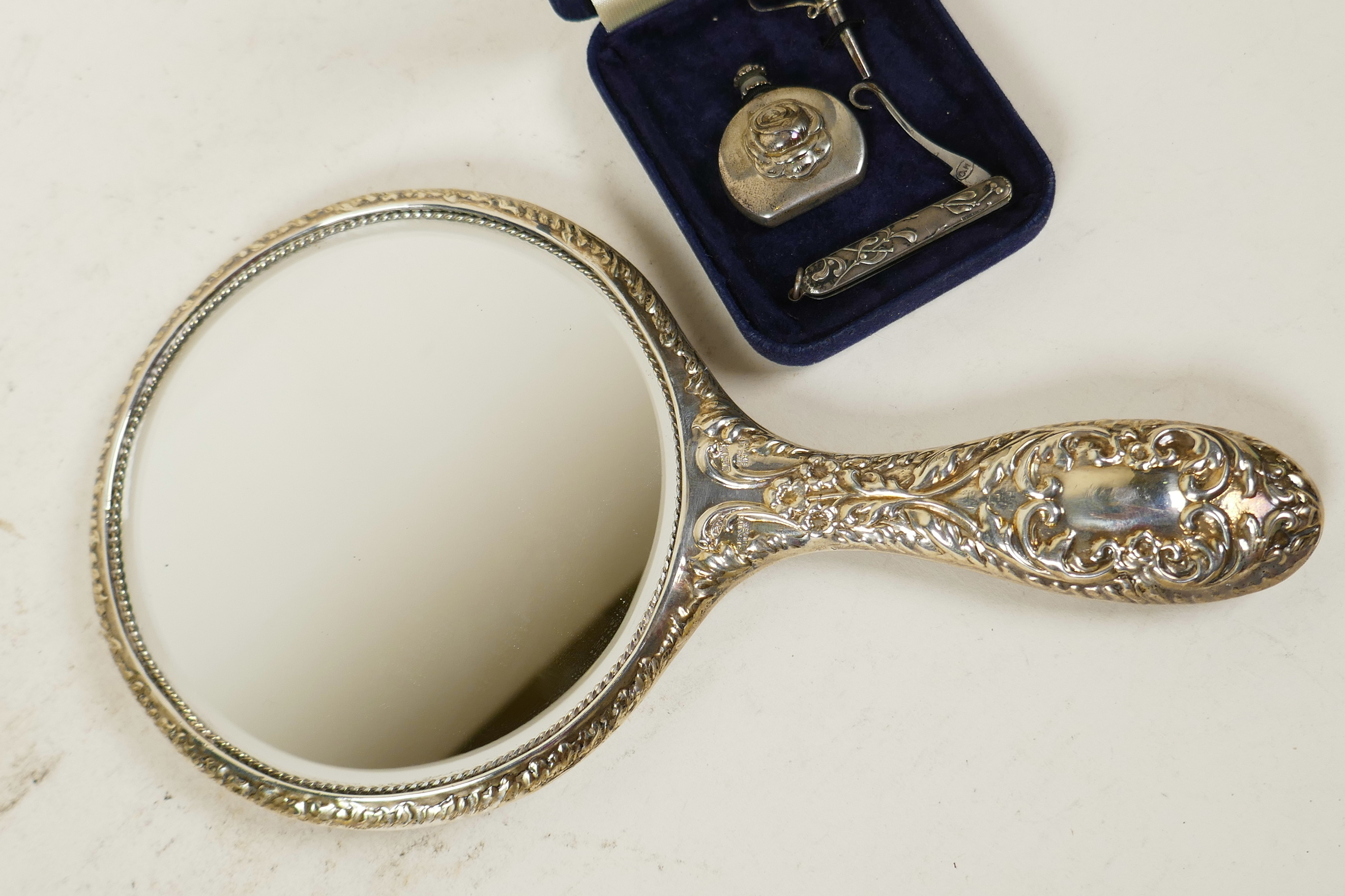 An embossed silver cherub hand mirror together with a silver perfume flask and funnel, and a - Image 4 of 4