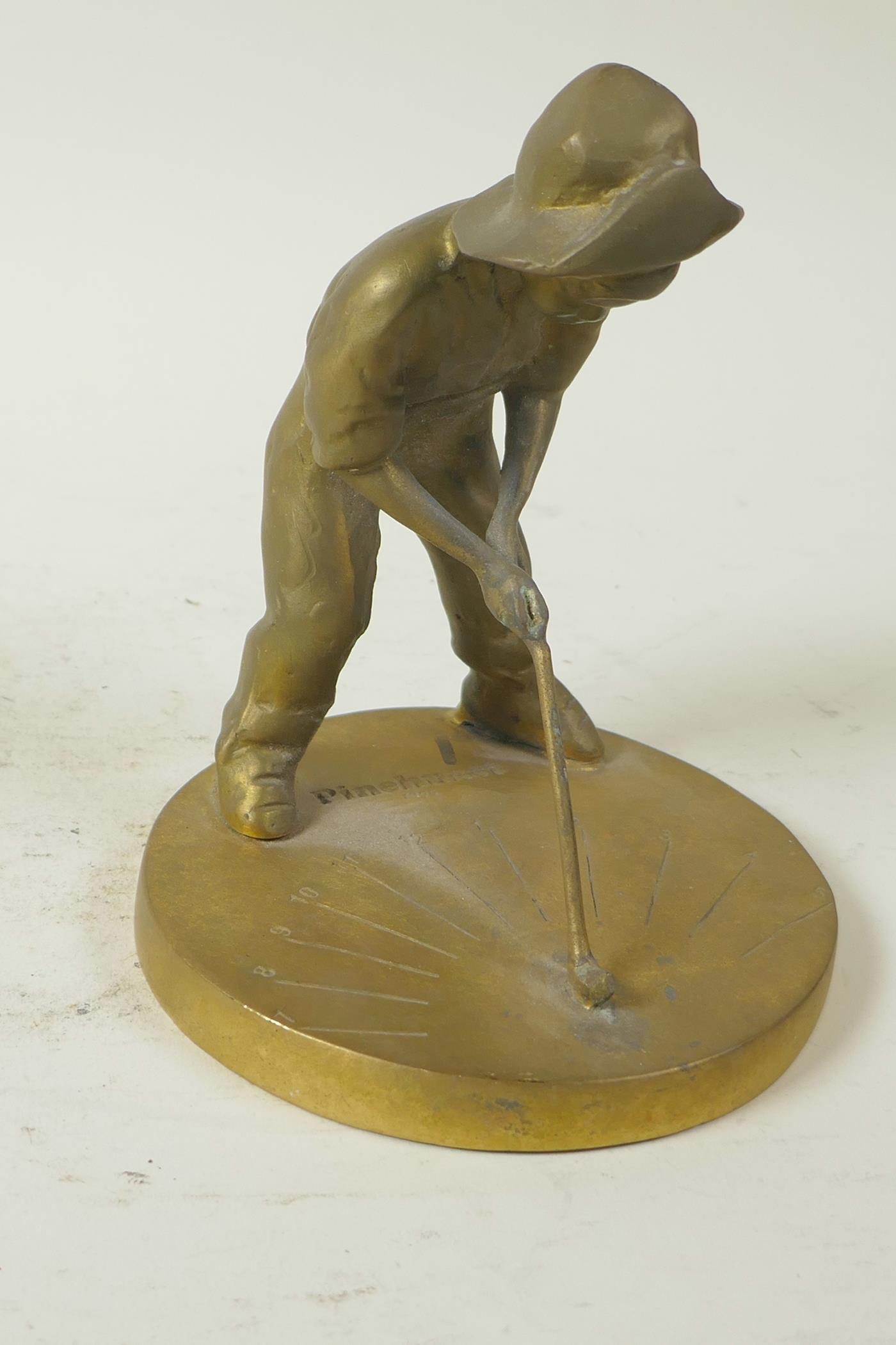 A small brass sundial cast as a young boy playing golf, 5¼" high - Image 2 of 4