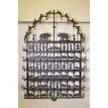 A painted wrought metal Divali screen, fitted with candle holders and bells, and decorative