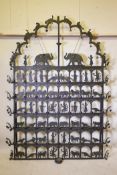 A painted wrought metal Divali screen, fitted with candle holders and bells, and decorative