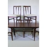 A mid century Afromosia 'Fonseca' dining table and six matching chairs, with tapered back splats,