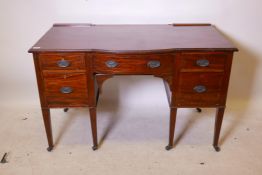 A C19th Maple & Co Ltd five drawer mahogany kneehole dressing table, with bow fronted middle and