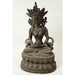 A Chinese bronze figure of Buddha seated in meditation on a lotus throne having coppered patination,