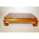 An oriental elm coffee table with six inset glass panels, 30" x 52", 14" high