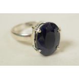 A sterling silver gemstone ring, inset with a 9ct dark blue sapphire, oval cut, hallmarked, 7g total
