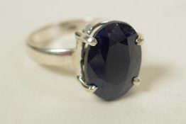 A sterling silver gemstone ring, inset with a 9ct dark blue sapphire, oval cut, hallmarked, 7g total