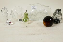 A collection of glass paperweights; a Kosta glass plaque of polar bears, a Mats Jonasson squirrel,