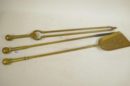 A C19th three piece brass companion set of tongs, poker and shovel with turned brass ball handles,