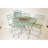 A vintage painted metal garden table and four matching chairs, 28" high, 35½" diameter