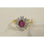 An 18ct gold set diamond and ruby cluster ring, size 'R'