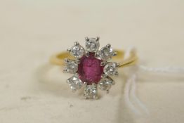 An 18ct gold set diamond and ruby cluster ring, size 'R'