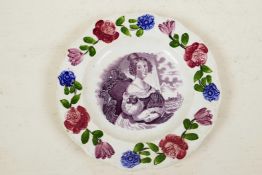 A C19th creamware wall plate, the border embossed and painted with flowers, the centre transfer