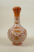 A Chinese red and white porcelain garlic head shaped vase decorated with lotus flowers, auspicious