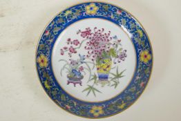 A Chinese polychrome porcelain cabinet dish decorated with flowers in a vase, 6 character mark to