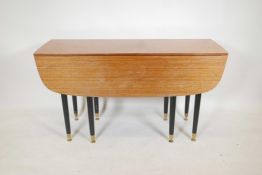 A 1950s G-Plan 'Librenza Tola' teak dropleaf table with a gateleg action, designed by E Gomme, on