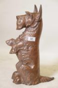 A vintage cast iron and copper doorstop/fireside companion in the form of a begging Angus terrier,