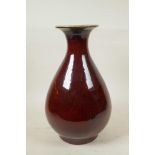 A Chinese flambe glazed pottery pear shaped vase, 13" high