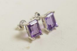 A pair of amethyst stud earrings on silver posts