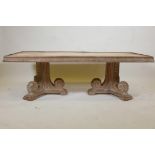 An Indian teak coffee table, with carved frieze, raised on two scrolled end supports, the top