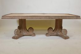 An Indian teak coffee table, with carved frieze, raised on two scrolled end supports, the top