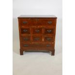 A walnut secretaire of small proportions, the fitted fall front secretaire over six small drawers