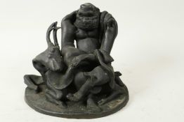 A Japanese bronze figure of an ugly man sitting on a deer, 6" high