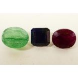 A set of three colour enhances gemstones, a 3.65ct ruby, 5.40ct emerald and a 4.20ct blue