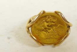 A 9ct gold mounted half sovereign ring, size 'S', gross 10.5 grams