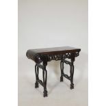 A Chinese hardwood low table with carved and shaped legs and frieze, adapted, 28½" x 13", 23½" high