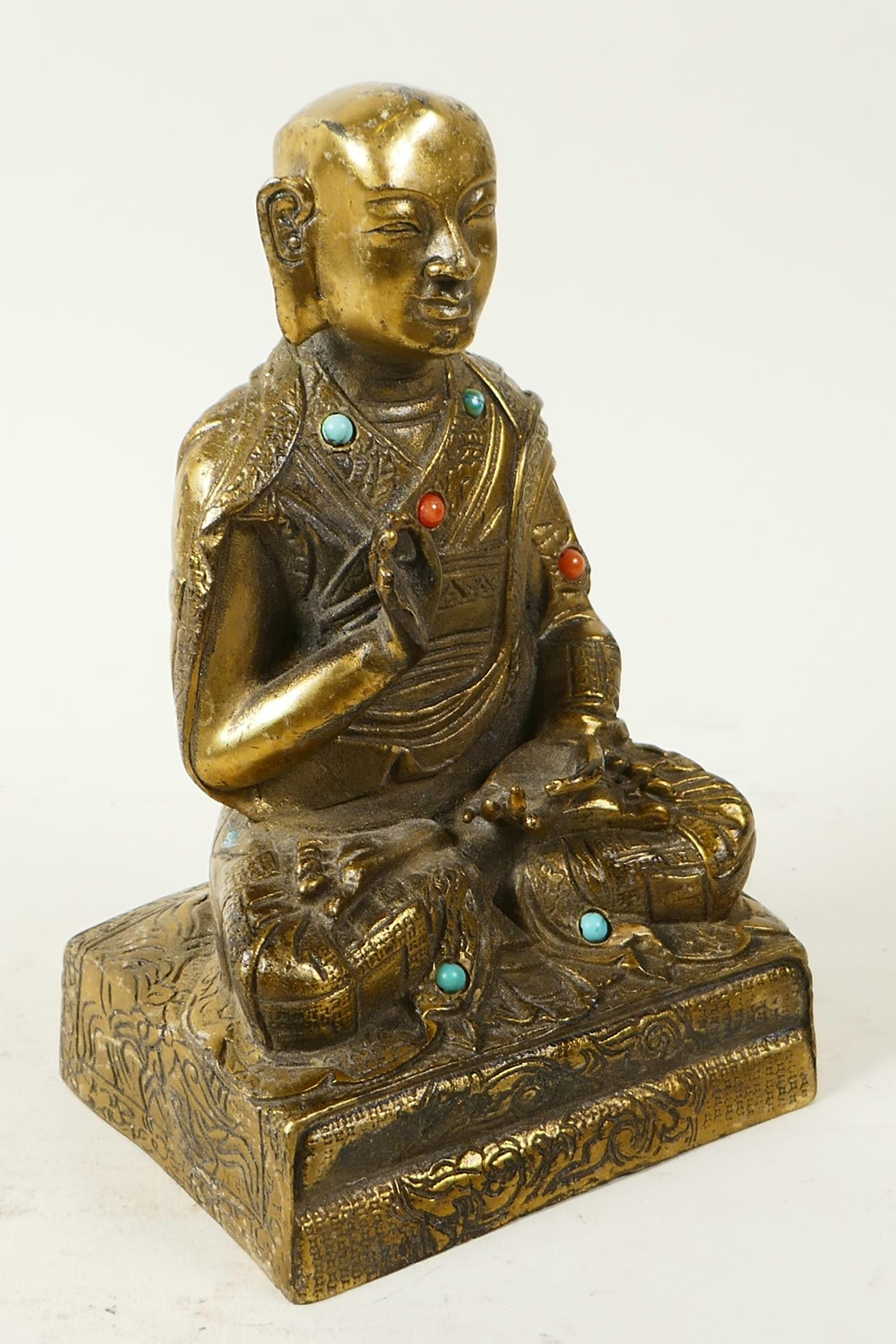 A Sino-Tibetan brass figure of Buddha seated in meditation having engraved decoration and set with - Image 2 of 5