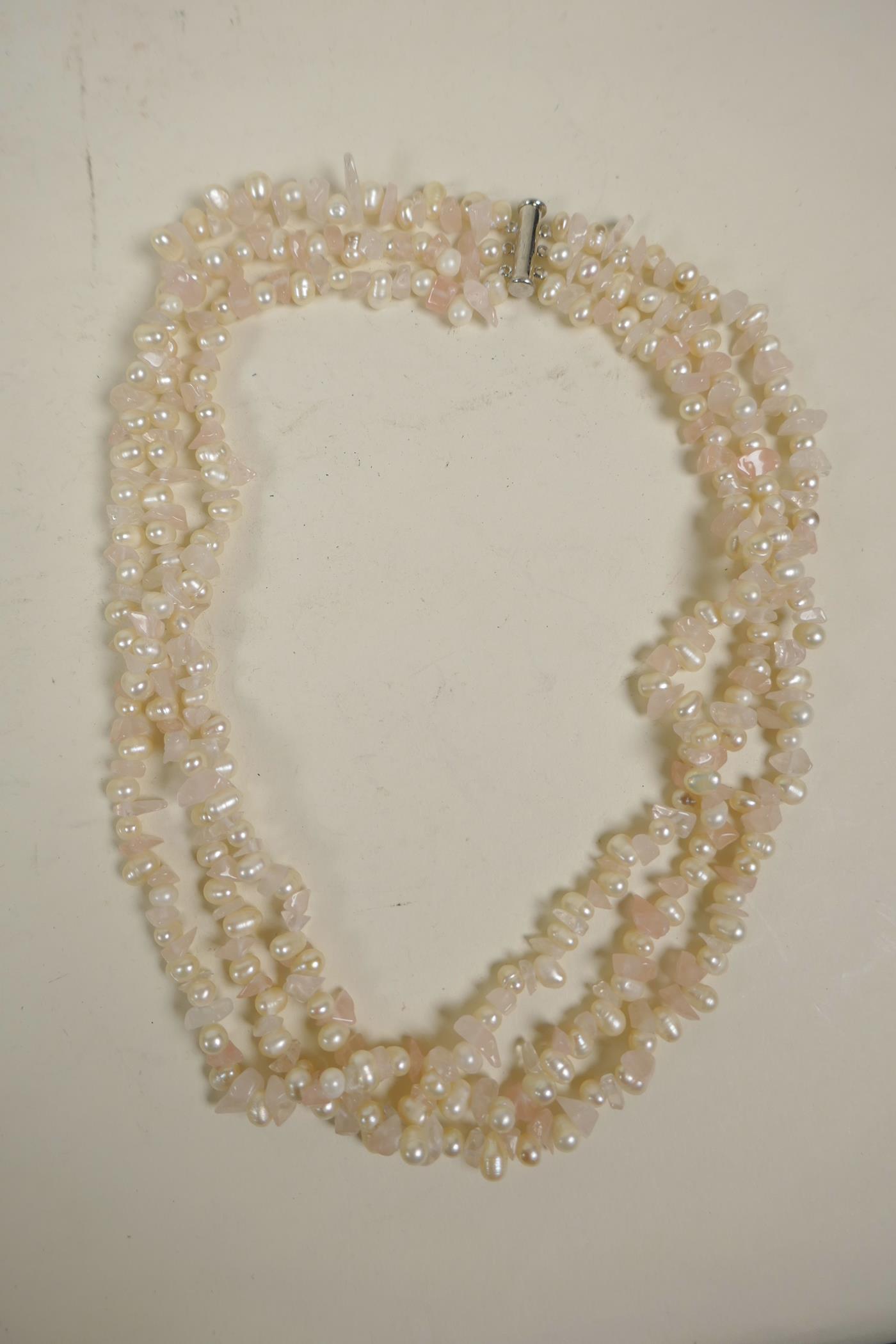A freshwater pearl and rose quartz triple strand necklace, 18" long