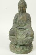 A Chinese bronze figure of Buddha seated in meditation on a lotus throne, having green patination,