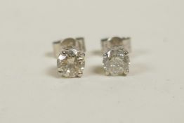 A pair of 14ct white gold diamond stud earrings, 64 points