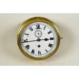 A brass cased ship's bulkhead clock with white dial, Roman numerals and secondary seconds dial, 8"