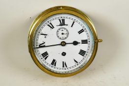 A brass cased ship's bulkhead clock with white dial, Roman numerals and secondary seconds dial, 8"