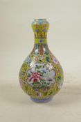 A Chinese polychrome porcelain garlic head shaped vase with decorative panels depicting flowers