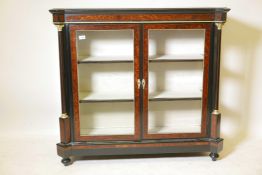 A good C19th ebonised two door pier cabinet with amboyne inset panels and ormolu mounts, raised on