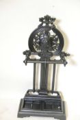 A replica cast iron Victory stick stand with iron drip trays and wheel on classical profile