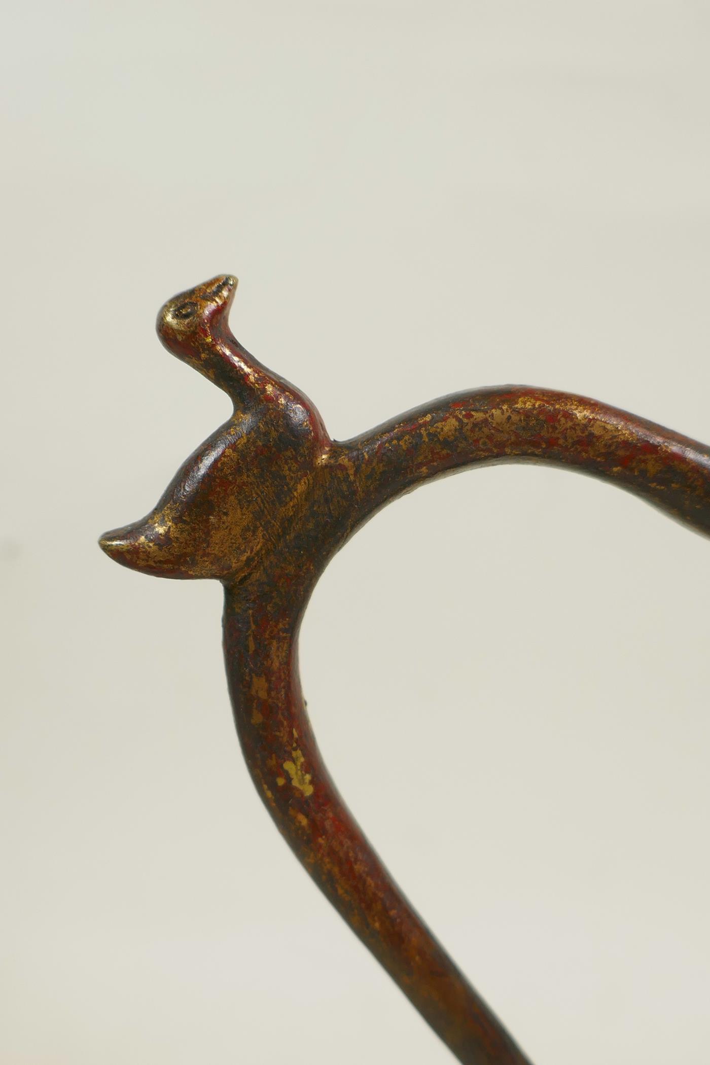 An Islamic bronze ewer with a ribbed body, twist spout and gilt patina, 9" high - Image 3 of 6