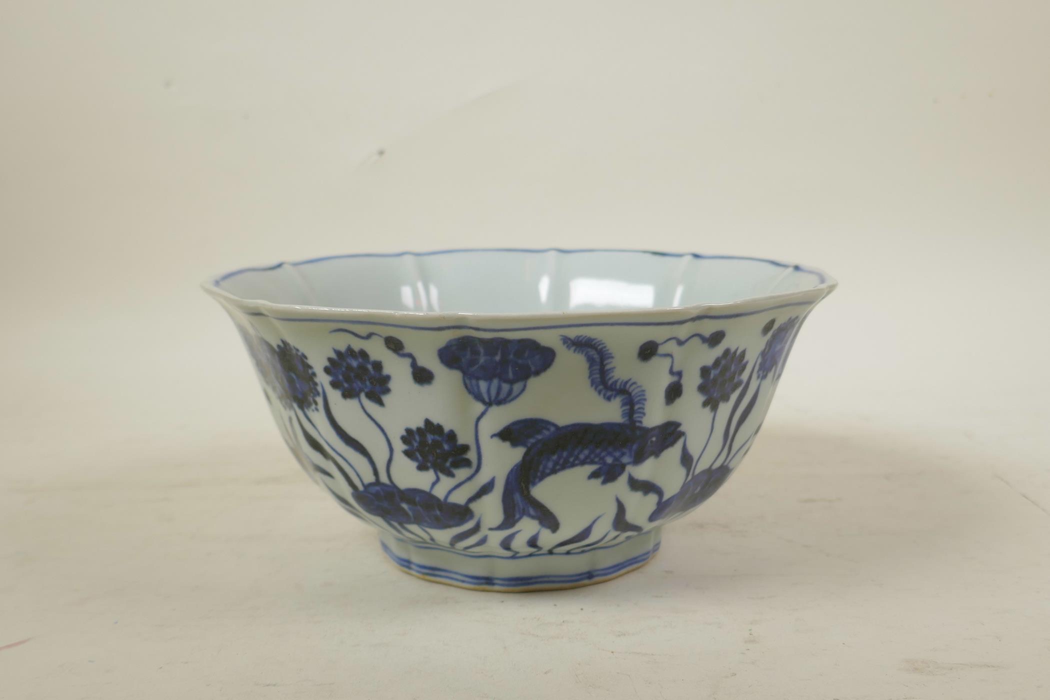 A Chinese Ming style blue and white porcelain bowl of lobed form, decorated with carp in a lotus - Image 2 of 7