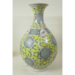 A Chinese yellow glazed porcelain vase of bulbous form with narrow neck and flared rim decorated